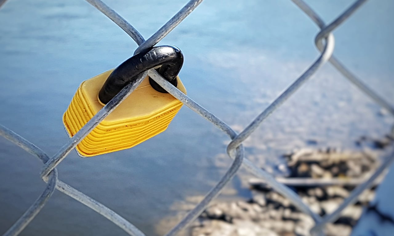 A padlock on a chain fence indicating private property