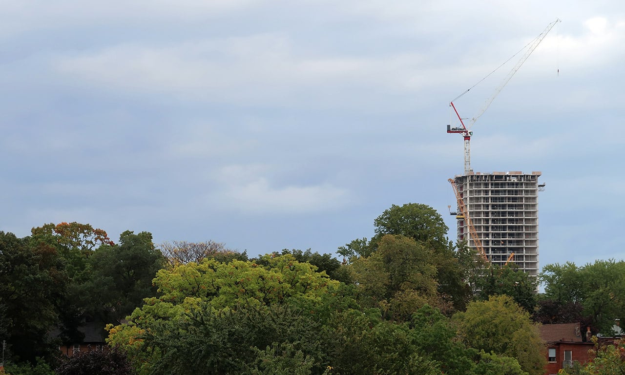 crane on top of a building in the landscape