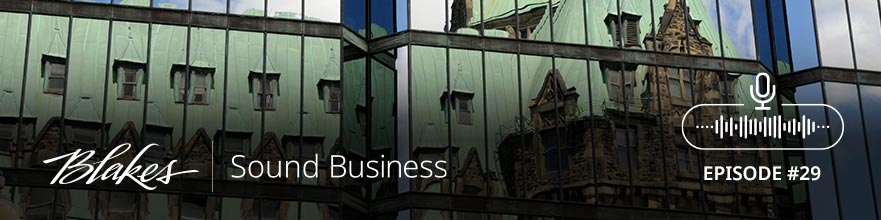 Banner image of Canadian Parliament building reflected in office building window