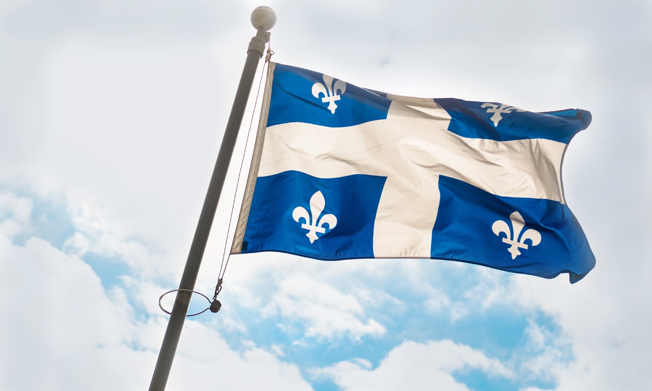 Quebec flag waving in clouds